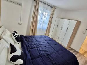 a bedroom with a bed with a blue comforter at Le Repos Blue Apartment in Pereybere