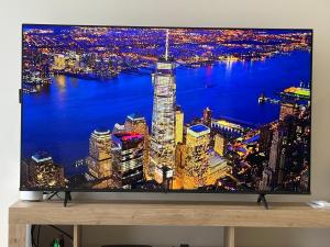 a television screen with a picture of a city at night at Residenza Orchidea in Tarquinia
