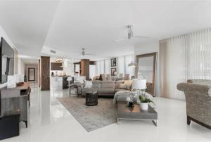 a white living room with a couch and a table at Southeast Oceanfront Residence in Hollywood Beach