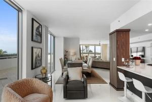 a living room with a kitchen and a dining room at Southeast Oceanfront Residence in Hollywood Beach