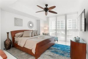 a bedroom with a bed and a ceiling fan at Southeast Oceanfront Residence in Hollywood Beach +26 photos