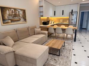 a living room with a couch and a table at Center Oasis Apartments in Tirana