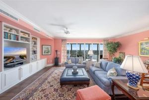 a living room with pink walls and a blue couch at Spacious Gulf-view Residence in Naples