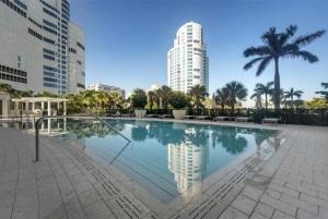 a large swimming pool in a city with tall buildings at Spacious Gulf-view Residence in Naples