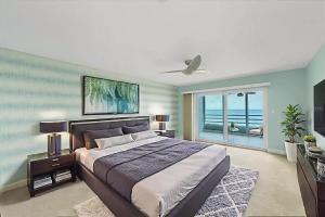 a bedroom with a bed and a view of the ocean at Beachfront Three Bedroom Condo with Ocean Views in Venice