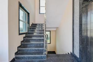 a staircase in a building with a window at Hotel O SSR Grand in Surūrnagar