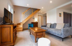 a living room with a couch and a tv at Awesome Home In Bacilly With Wifi in Bacilly