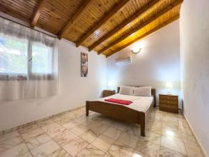 a bedroom with a bed and a large window at SIX INDEPENDENT HOUSES BY THE sea in Glífa