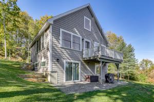 a house with a balcony on the side of it at Sunny Stockton Springs Home Less Than 1 Mi to Beach! in Stockton Springs