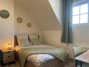 a small bedroom with a bed and a window at Vue Cathedrale, Elegance & Lumière à Amiens in Amiens