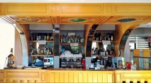 a bar with a lot of bottles on shelves at Hotel Sfinks in Elbasan