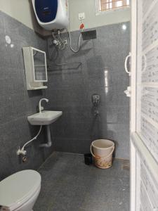 a bathroom with a toilet and a sink at AVANI Stays in Yelagiri