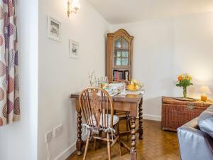 a room with a desk with a chair and a mirror at Horseshoe Cottage-Uk37360 in Lympsham