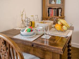 a wooden table with a bowl of eggs on it at Horseshoe Cottage-Uk37360 in Lympsham
