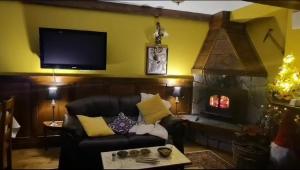 a living room with a couch and a fireplace at Soupiets in Betpouey