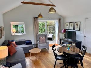 a living room with a couch and a table at The Cottage in Bristol