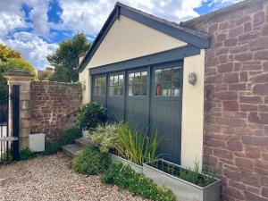 a blue garage door on a brick house at The Cottage in Bristol