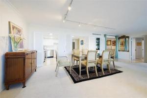 a dining room and living room with a table and chairs at Spacious Three Bedroom Condo with Lake Views in Lakeside Green +22 photos