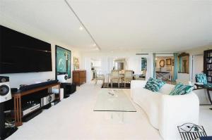 a living room with a white couch and a flat screen tv at Spacious Three Bedroom Condo with Lake Views in Lakeside Green