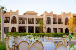 a table set up for a wedding in front of a building at Palais Nouhass in Marrakech