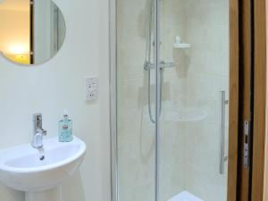 a bathroom with a shower and a sink at The Byre in Rispond