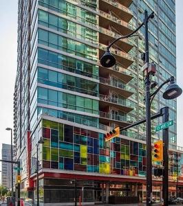 a tall building with colorful windows and a traffic light at Modern Beltline Escape Sky-High Views DT Views in Calgary