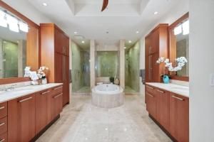 a bathroom with two sinks and a bath tub at Penthouse In The Sky With Water Views in Naples +20 photos