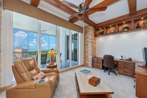 a living room with a couch and a table at Penthouse In The Sky With Water Views in Naples