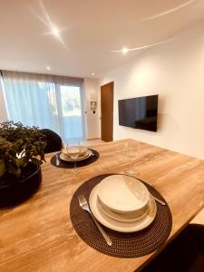 a dining room table with plates and glasses on it at Appartement Fiorentina in Saint-Avold