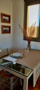 a table with a plate and a wine glass at Cubos habitables 3 in San Antonio de Arredondo +7 photos