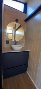 a bathroom with a sink and a mirror at Cubos habitables 3 in San Antonio de Arredondo