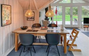 a dining room with a wooden table and chairs at 2 Bedroom Stunning Home In Martofte in Martofte
