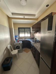 a small kitchen with a washing machine in it at Dar AMIRA in Ben Yakhlef