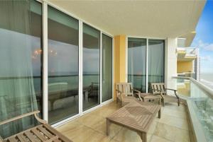 a balcony with chairs and a table on a building at Ocean & Intercoastal Views in Sunny Isles Beach