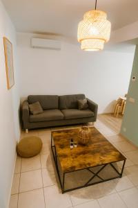 a living room with a couch and a coffee table at La Terrasse - Centre-ville - Parking - Netflix in Valence