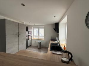 a kitchen with a sink and a counter top at Le Gîte des Vosges in Anould