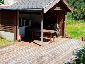 a building with a picnic table on a deck at 8 person holiday home in jørpeland-By Traum in Jørpeland