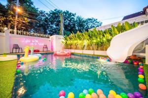 a pool with a slide and a water park at Villa 53 Wongamat 4BR, 300M from The beach in Pattaya North