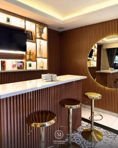 a bar with two stools and a counter at Hotel Boutique Casa Monarca in El Paraíso