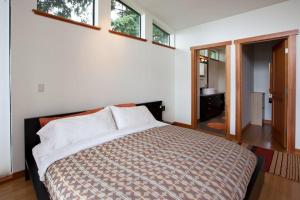 a bedroom with a bed and two windows at Bridge View Loft 30 Day in Hood River +18 photos