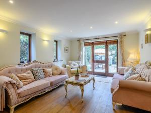 a living room with two couches and a table at The Old Gatehouse in Heacham