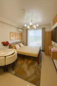 a bedroom with a large bed and a table at Luxury Condo-Sea View- Near Beach in Lapu Lapu City