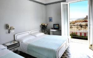 Postel nebo postele na pokoji v ubytování Hotel Biagini