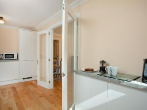 a kitchen with white cabinets and a counter top at 1 The Folly's - Uk45189 in Abbotskerswell