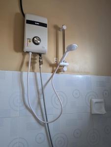 a shower in a bathroom with a hair dryer at L'islo INN in Davao City