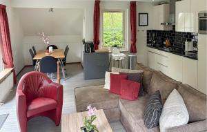 a living room with a couch and a kitchen at Stunning Home In Exloo With Wifi in Exloo