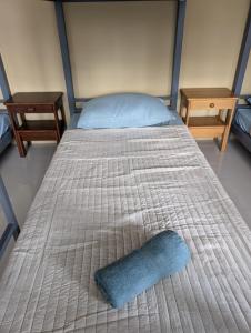 a bed with a blue pillow on top of it at L'islo INN in Davao City