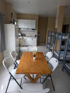 a table and chairs in a room with a kitchen at L'islo INN in Davao City