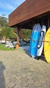a group of surfboards are parked under a building at Floripa Glamping in Florianópolis
