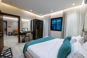 a bedroom with a bed and a desk in a room at Mabaat-Deluxe 1BR Al Waha 621 in Jeddah